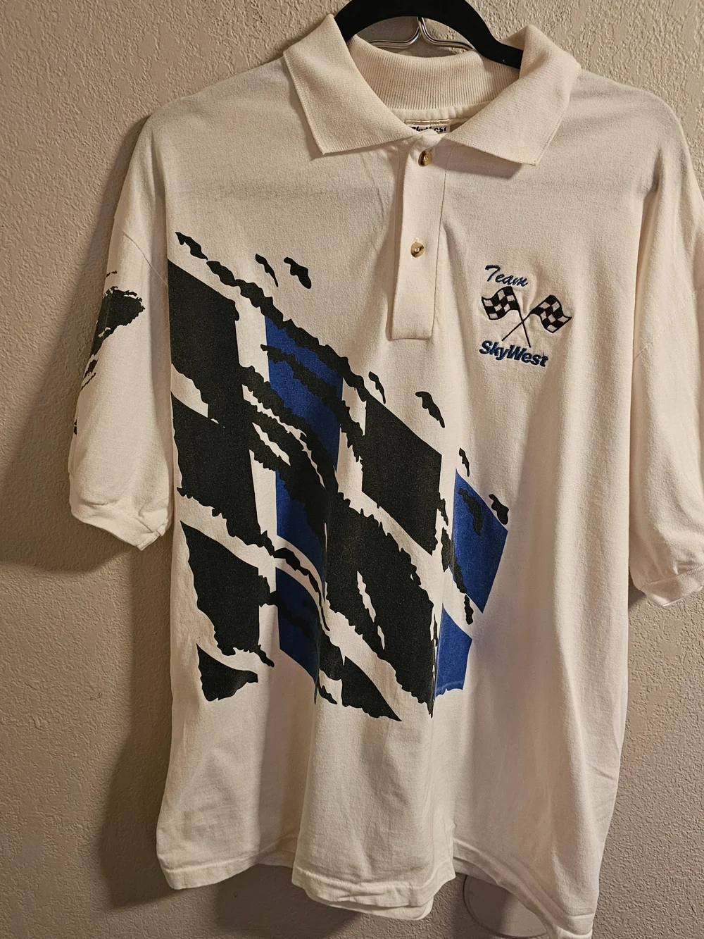 Team SkyWest Airlines polo shirt featuring a bold blue-and-black abstract side